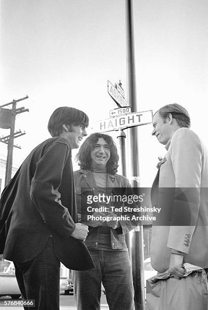 Jerry Garcia and Rock Scully , manager of the rock band the Grateful Dead, speak to author Tom Wolfe at the corner of Haight and Ashbury.