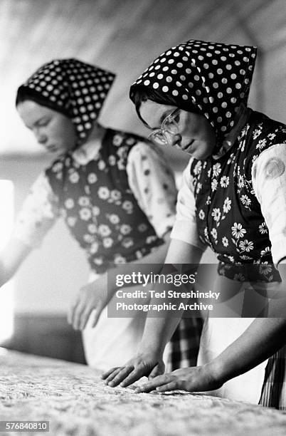 Two Hutterite women prepare to make noodles. A fundamentalist religious sect, Hutterites require all females to cover their heads with polka-dot...