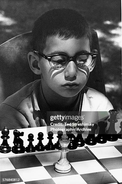 Portrait of Boy Concentrating on Chess Game