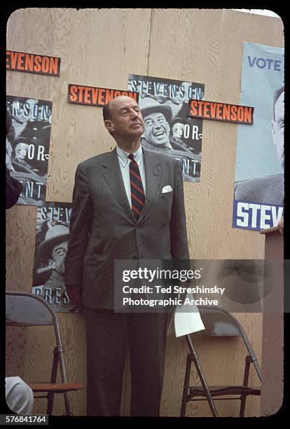 Adlai Stevenson proudly stands before a wall of campaigning posters before delivering a campaign speech at the University of California at Berkeley....