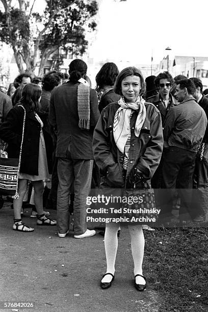 Writer Joan Didion stands at the panhandle of Golden Gate Park with a group of hippies during the writing of her article Slouching Towards Bethlehem....