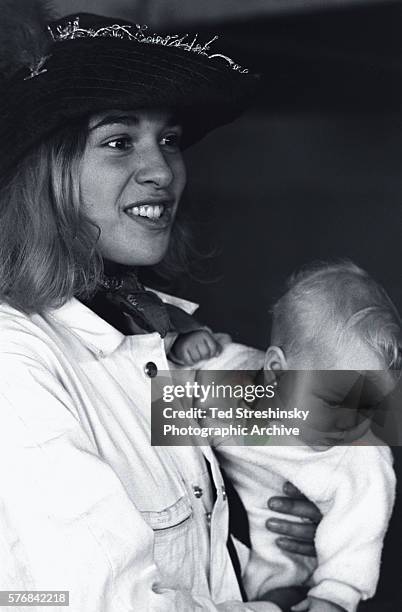 Ken Kesey's girlfriend Mountain Girl holds their baby Sunshine.