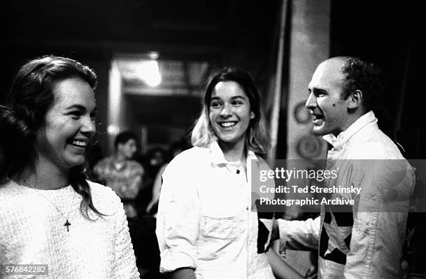 Ken Kesey and his wife Faye talk with his girlfriend Mountain Girl .