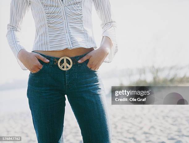 young woman wearing belt with peace symbol - buckle stock pictures, royalty-free photos & images