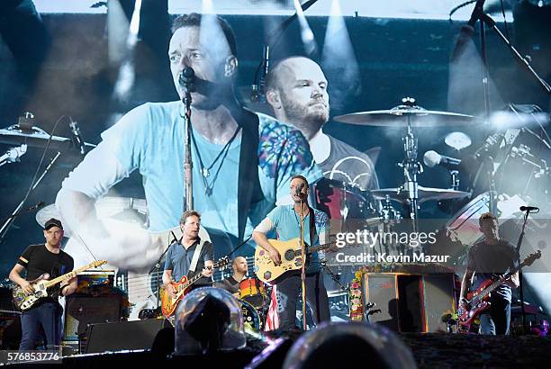 Recording artist Jonny Buckland, actor Michael J. Fox, and recording artists Will Champion, Chris Martin, and Guy Berryman of Coldplay perform...