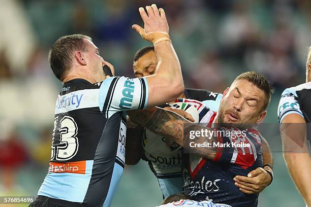 Paul Gallen of the Sharks tackles Jared Waerea-Hargreaves of the Roosters during the round 19 NRL match between the Sydney Roosters and the Cronulla...