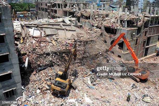 In this photograph taken on May 3 Bangladeshi rescuers use diggers to move debris as Bangladeshi Army personel continue the second phase after the...