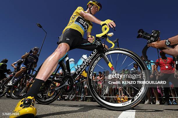 Great Britain's Christopher Froome, wearing the overall leader's yellow jersey, waits for the start of the 209 km sixteenth stage of the 103rd...