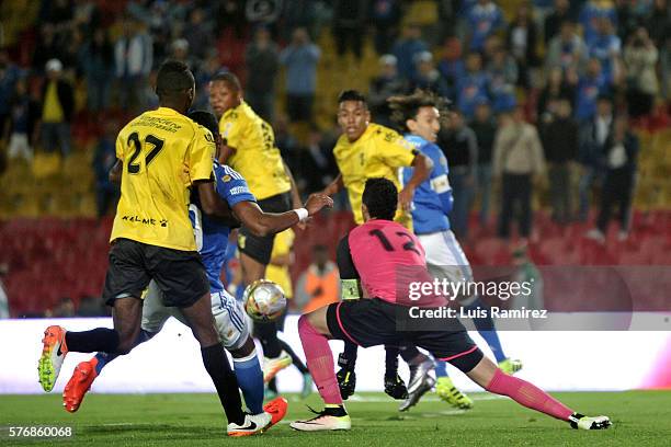 Andres Escobar of Millonarios vies for the ball with Ricardo Jerez of Alianza Petrolera, during a match between Millonarios and Alianza Petrolera as...