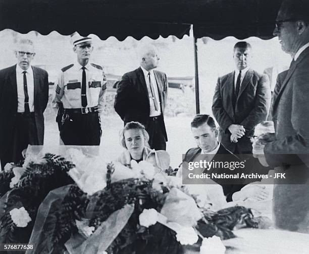 Family members mourn the death of Lee Harvey Oswald at his funeral at Rose Hill Memorial Park in Fort Worth, Texas. Seated from left are Marina...