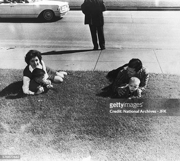 Onlookers drop to the ground after shots are fired at Dealy Plaza during the assassination of President Kennedy on November 22, 1963.