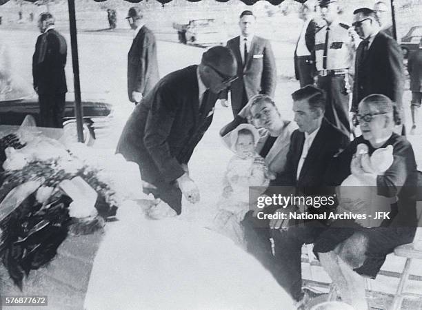 Clergyman speaks with family members of Lee Harvey Oswald at his funeral at Rose Hill Memorial Park in Fort Worth, Texas. Seated from left are Marina...