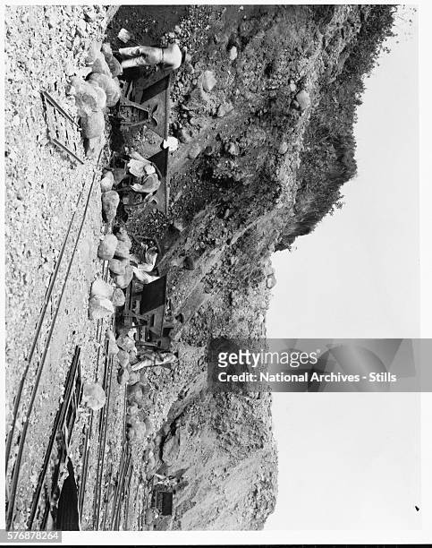 Workers hand excavate a channel in Gatun Lake during the construction of the Panama Canal.