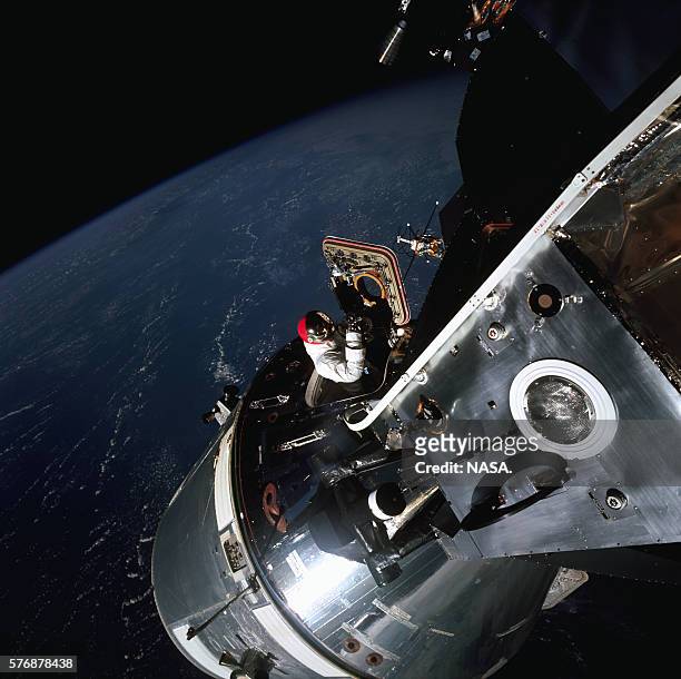 Apollo 9 astronaut Dave Scott opens the hatch of the command module and moves toward the lunar module nearby. Apollo 9 was a mission to test the...