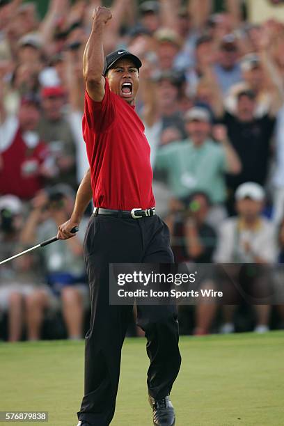 Tiger Woods celebrates after making a birdie putt at No. 18 in the first hole of a sudden-death playoff to win The Masters, his fourth, and ninth...