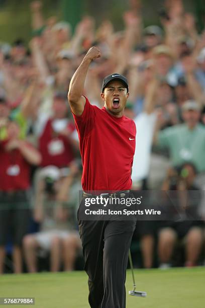 Tiger Woods celebrates after making a birdie putt at No. 18 in the first hole of a sudden-death playoff to win The Masters, his fourth, and ninth...