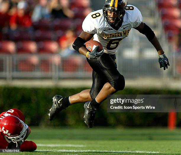 University of Southern Mississippi sophomore running back Larry Thomas goes airborne after being hit by University of Houston freshman cornerback...