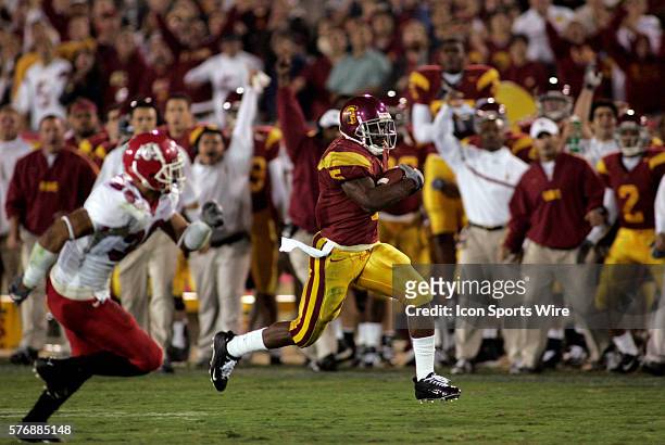 Reggie Bush of USC carries the ball against Fresno State Bulldogs at Memorial Coliseum in Los Angeles, CA. USC defeated Fresno St. 50-42 to extend...