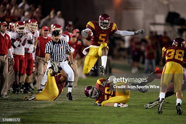 Reggie Bush of USC carries the ball against Fresno State Bulldogs at Memorial Coliseum in Los Angeles, CA. USC defeated Fresno St. 50-42 to extend...