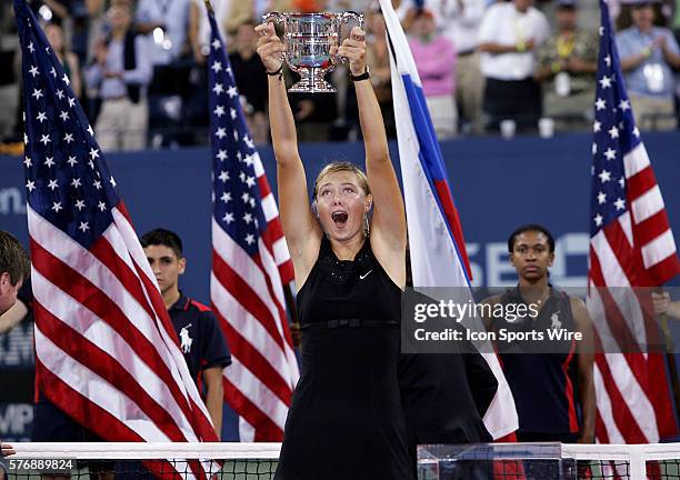 Maria Sharapova holds the champions trophy after defeating Justine Henin-Hardenne in the US Open Womans Final, 6-4, 6-4 in Flushing Meadows, New York.