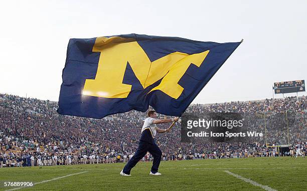 Michigan cheerleader waves the school banner after the Wolverines final touchdown of the game as the Fighting Irish took on the visiting Michigan...