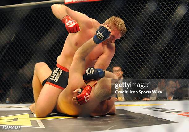 Josh Barnett gives Sergei Kharitonov a blow during the Semi-Final Heavyweight bout during the Strikeforce Grand Prix Semi-Finals at US Bank Arena in...