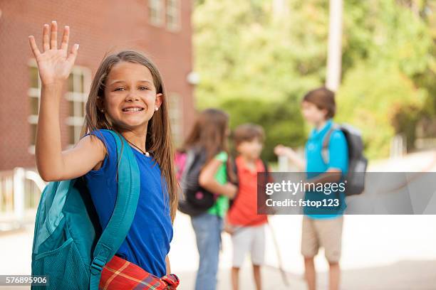 back to school:  elementary-age children, friends on school campus. - waving hand stock pictures, royalty-free photos & images