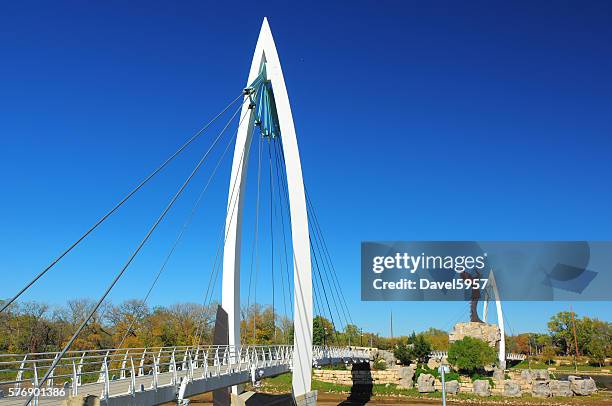 keeper of the plains suspension bridge and statue - wichita stock pictures, royalty-free photos & images