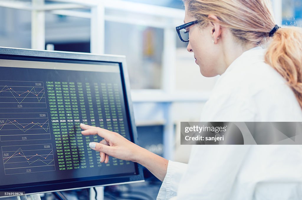 Scientist Interacting With The Computer Via Touch Screen