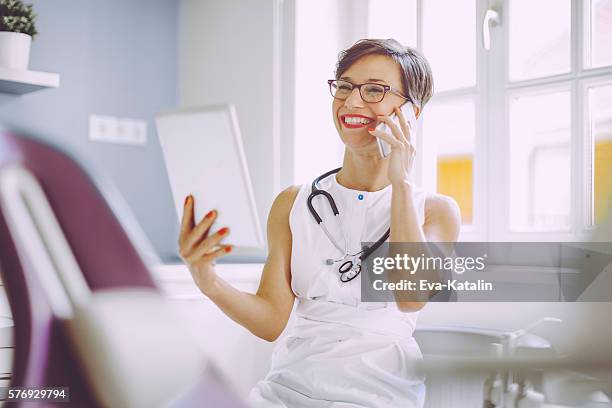 female doctor is working in the surgery - good news stock pictures, royalty-free photos & images
