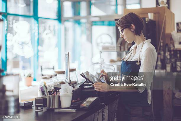 young barista is working in a café - coffee shop owner stockfoto's en -beelden