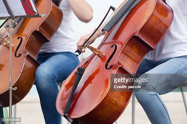 young adults playing cello - orchestra outside stock pictures, royalty-free photos & images
