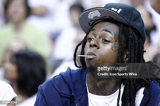 American rapper Dwayne Michael Carter, Jr., better known by his stage name Lil Wayne, is seen courtside during the Miami Heat 104-98 victory over the...