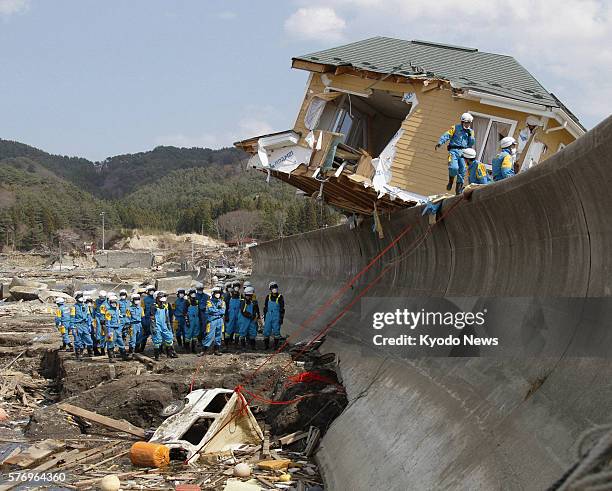 Japan - Members of the Wakayama prefectural police work to haul a sunken car at Kirikiri beach in the town of Otsuchi, Iwate Prefecture, on April 24,...