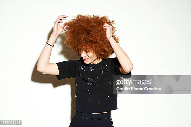 woman fixing her afro. - beautiful redhead photos et images de collection