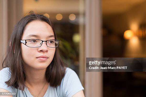 young asian girl in a restaurant - jean marc payet stock pictures, royalty-free photos & images