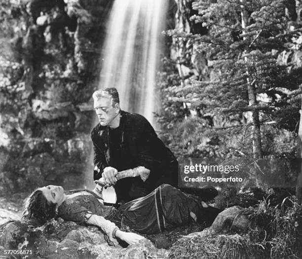 Actor Boris Karloff as the monster, leans over actress Elsa Lanchester in a scene from the film 'The Bride of Frankenstein', for Universal Pictures,...