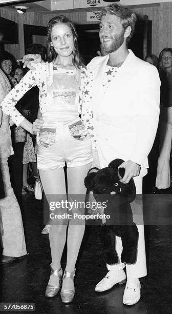 Actor Alexis Kanner and his model girlfriend, Annie Lambert, dressed in dungaree shorts, attend the premiere of the film 'Goodbye Gemini' at the...