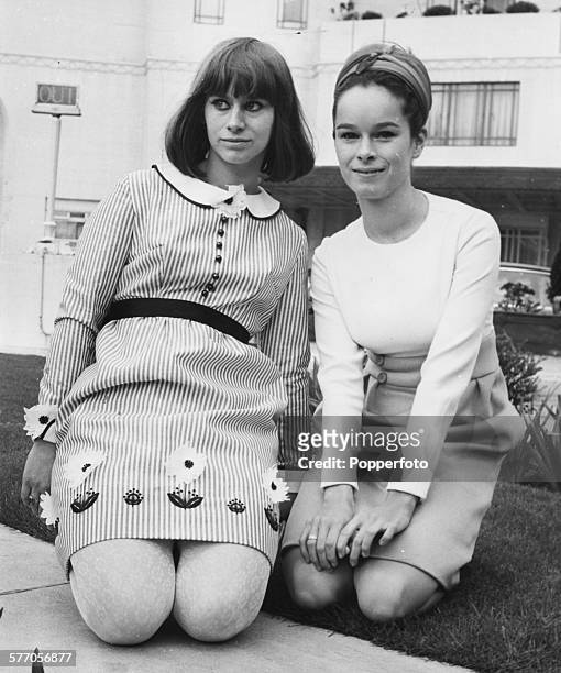 Portrait of actresses Rita Tushingham and Geraldine Chaplin kneeling on the grass during a break from their press conference to promote the new film...