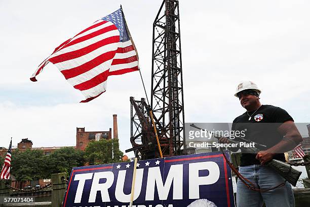 Donald Trump supporter poses with a gun while attending a rally for Trump on the first day of the Republican National Convention on July 18, 2016 in...