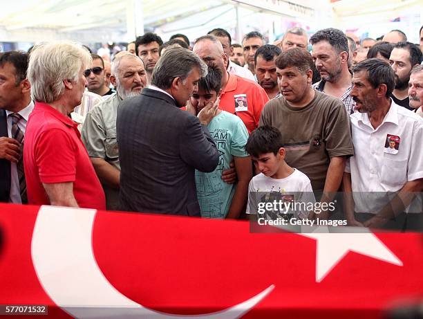 Former Turkish President Abdullah Gul gives his condolences to the relatives of killed Turkish police officer Erol Ince, a victim of the thwarted...