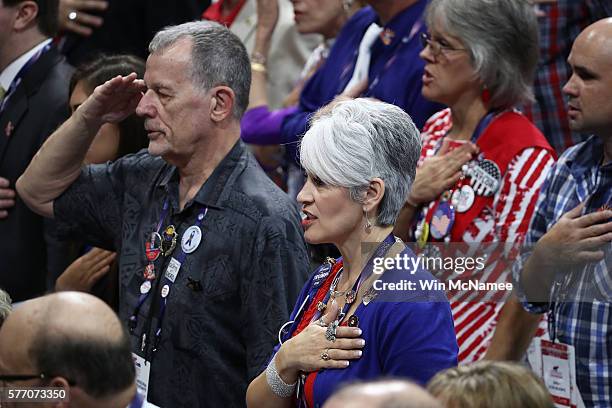 Delegates sing the national anthem before the start of the first day of the Republican National Convention on July 18, 2016 at the Quicken Loans...