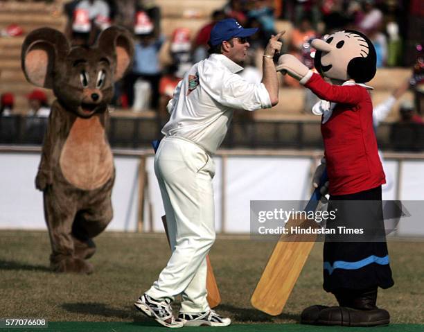 Mark Waugh jokes with cartoon character Olive Oil while Jerry looks on during toon cricket 2005 at Andheri on Sunday.