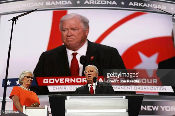 Former Gov. Haley Barbour speaks as Mary Buestrin , of the Republican National Committee, look on during the first day of the Republican National...