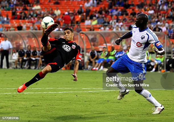 Luis Silva of DC United flings himself at a high cross in front of Hassoun Camara of the Montreal Impact during an MLS match at RFK Stadium, in...