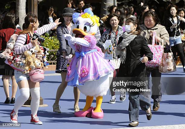 Japan - Visitors enter Tokyo DisneySea Park in Urayasu, Chiba Prefecture, on April 28 as the park reopened the same day ahead of the Golden Week...