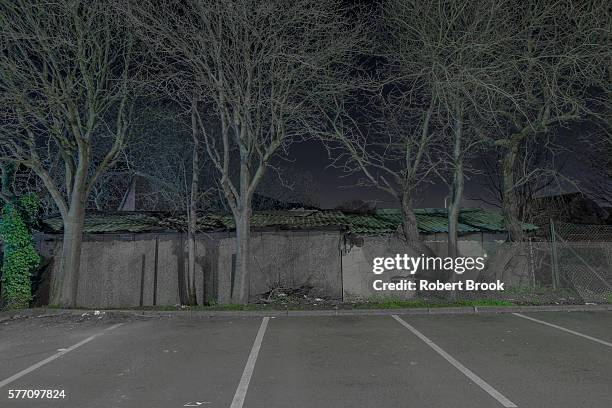 edge of empty car park at night - shedd brook stock pictures, royalty-free photos & images