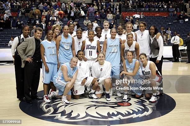 Uconn players past and present with the coaching staff From left to right standing are: Jamelle Elliott, Geno Auriemma, Rita Williams, Chris Dailey,...