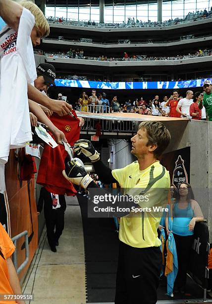 Manchester United goalkeeper Edwin van der Sar signs autographs before the MLS All-Star game. Manchester United defeated the MLS All-Stars 5-2 at...