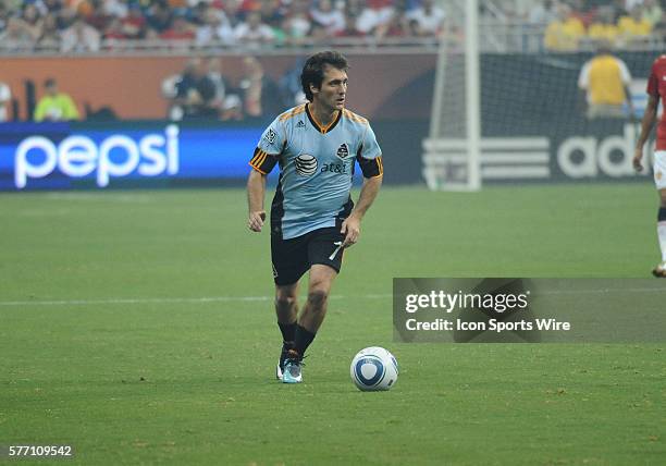 Guillermo Barros Schelotto of the MLS All-Stars looks for an open pass as he works the ball down the field in the second period of the MLS All-star...